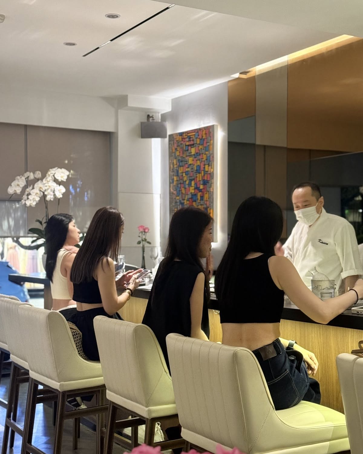 The chef with guests seated at Kasen’s omakase counter.